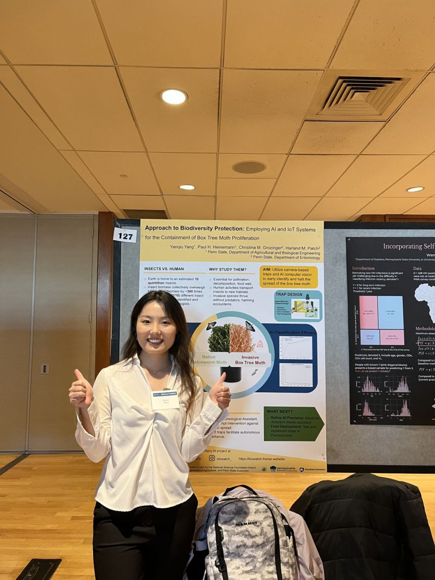 Yanqiu Yang in front of her award-winning poster at the Graduate Exhibition